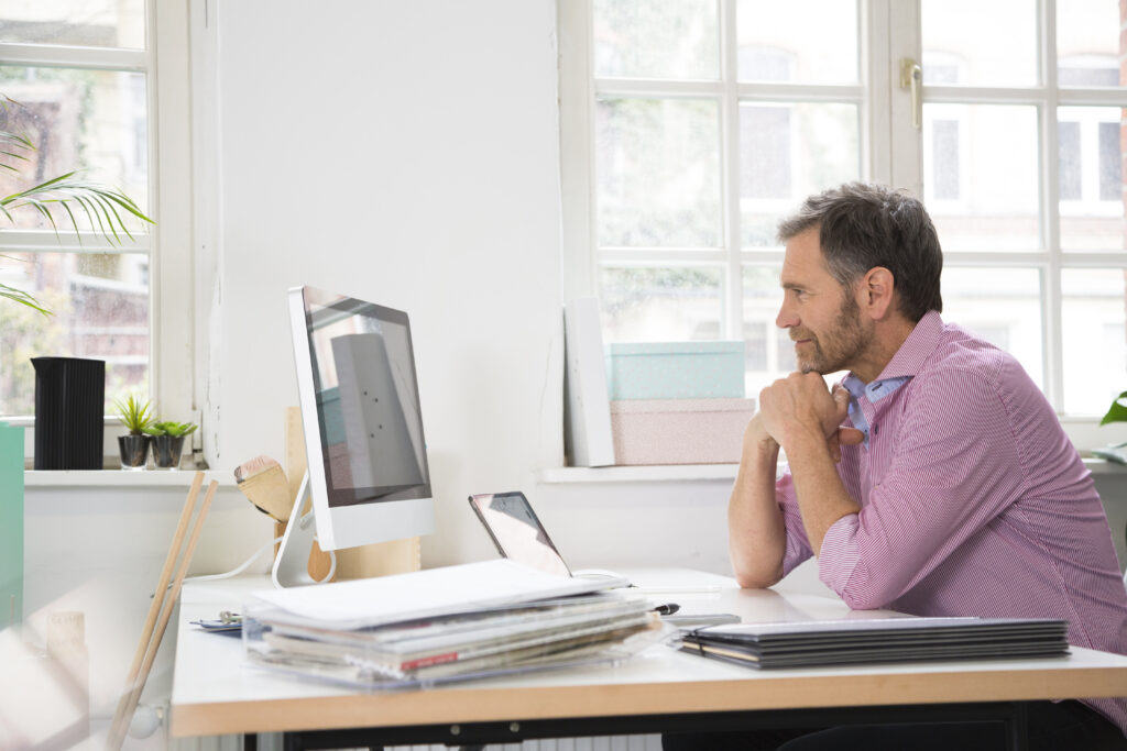 Smiling man working at desk in office